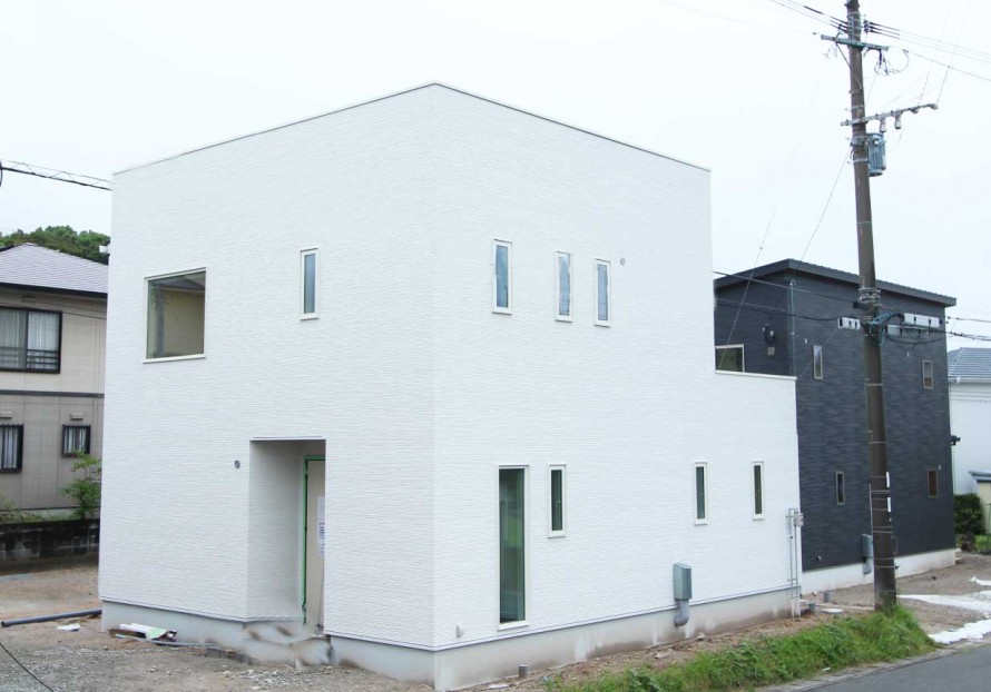 白を基調とした明るい雰囲気の二階建て。